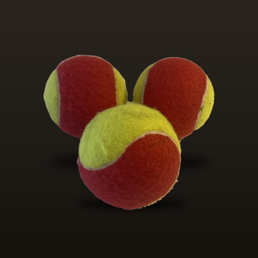 Three red and yellow kids practice tennis balls